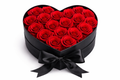 Heart-shaped box filled with red roses on a white background