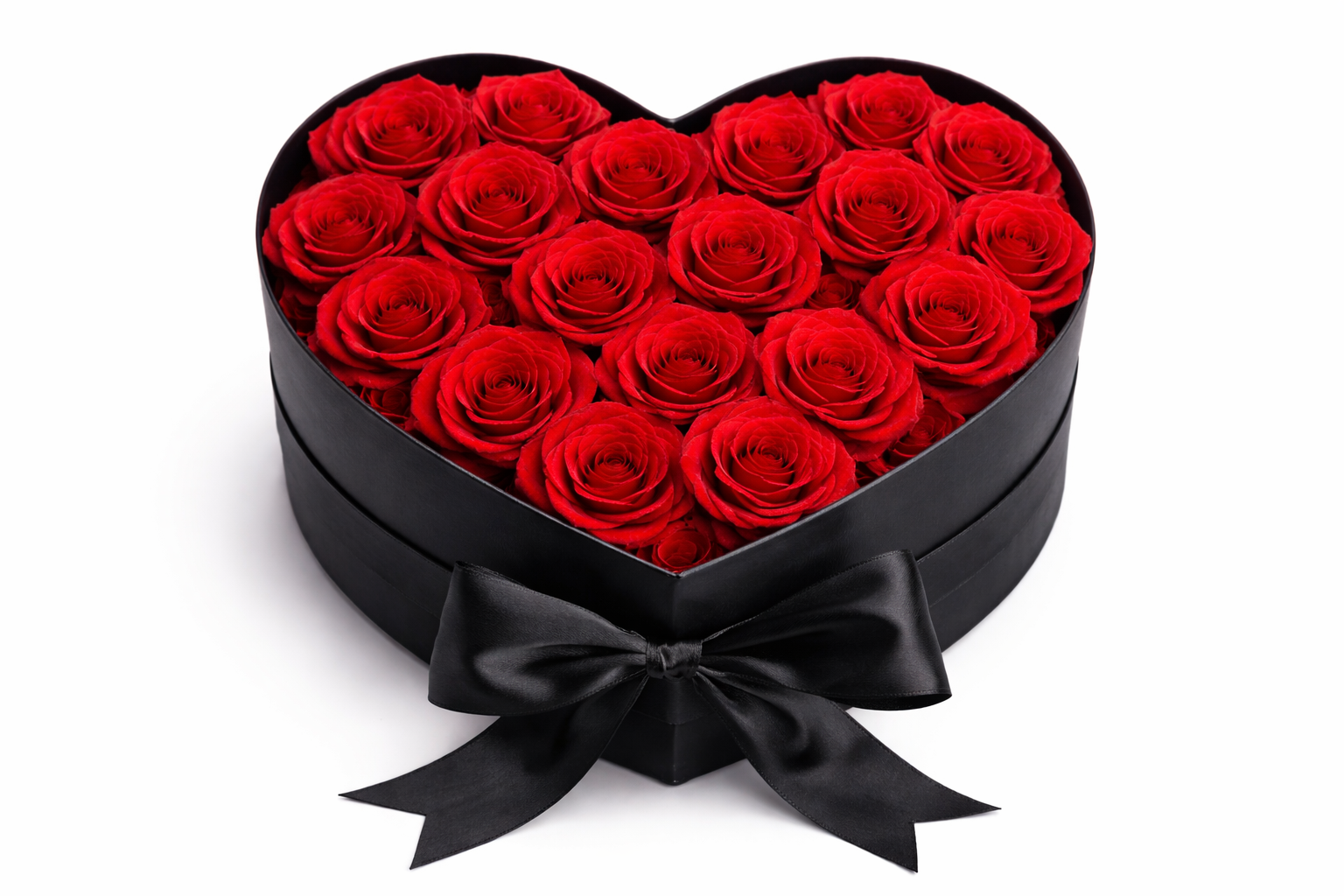 Heart-shaped box filled with red roses on a white background